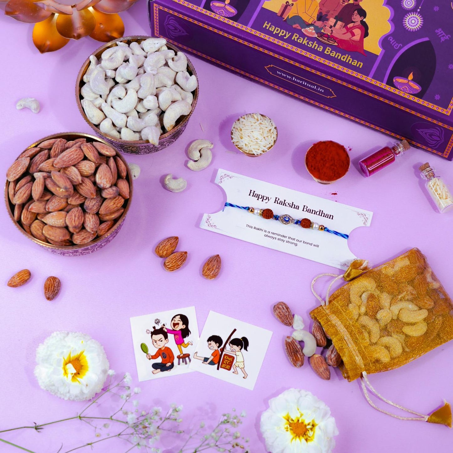 Evil eye rakhi with dry fruits, flowers, and Raksha Bandhan accessories on purple background.