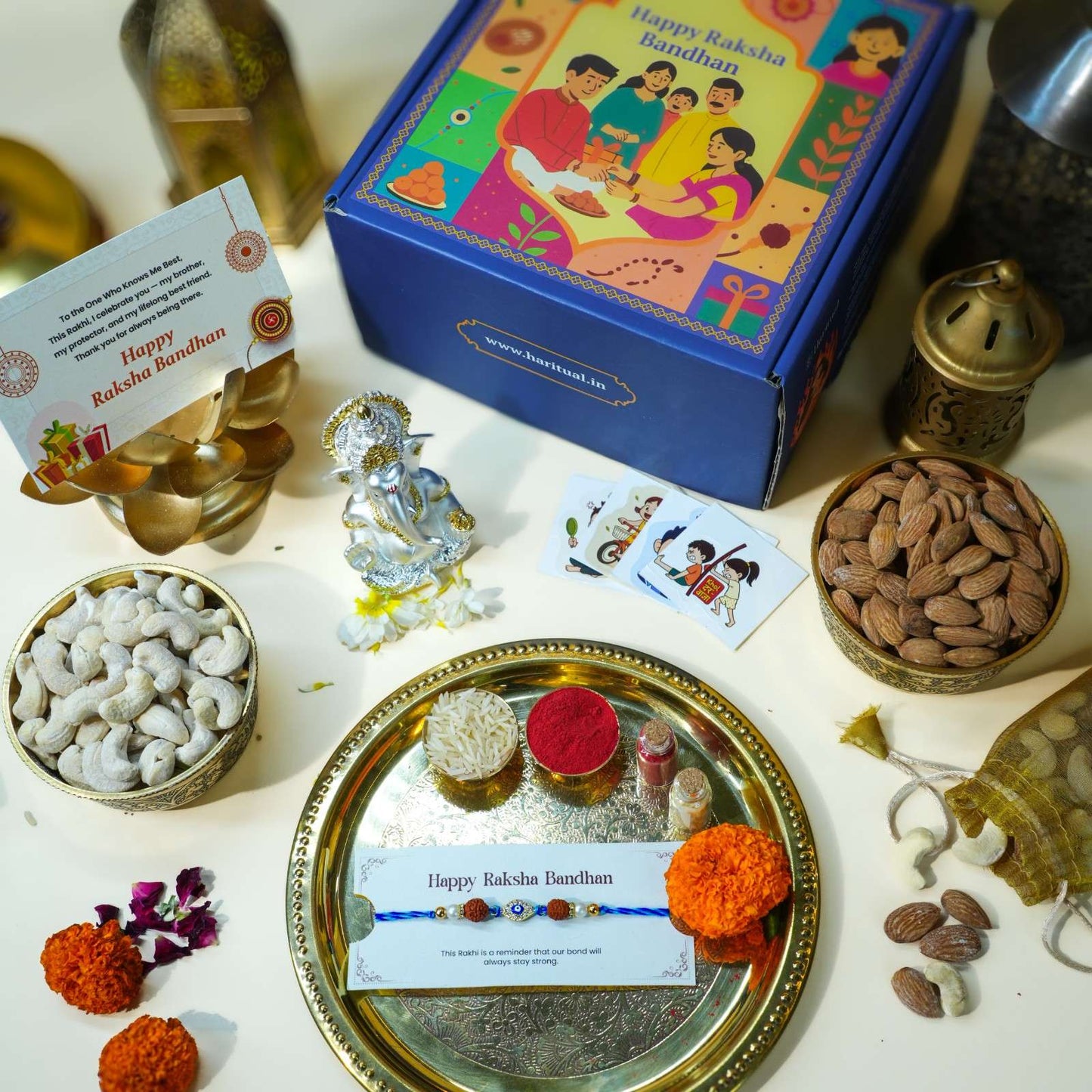 Raksha Bandhan gift set with Ganesha idol, Evil Eye Rakhi, dry fruits, and ritual thali.