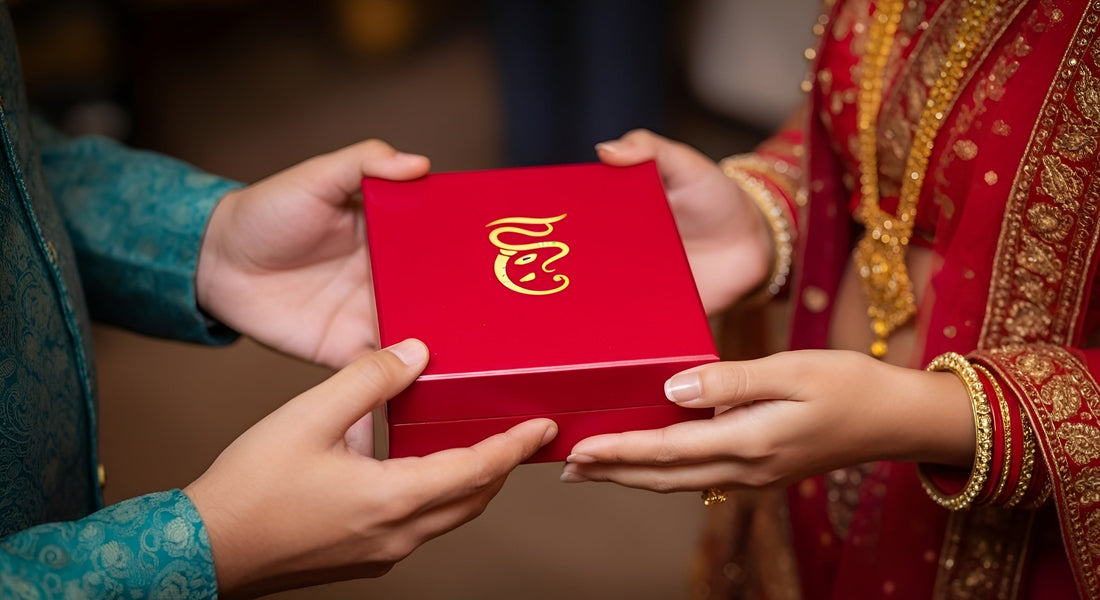 A close-up of two indian wedding guests gifting Haritual's idol to the Indian wedding couple