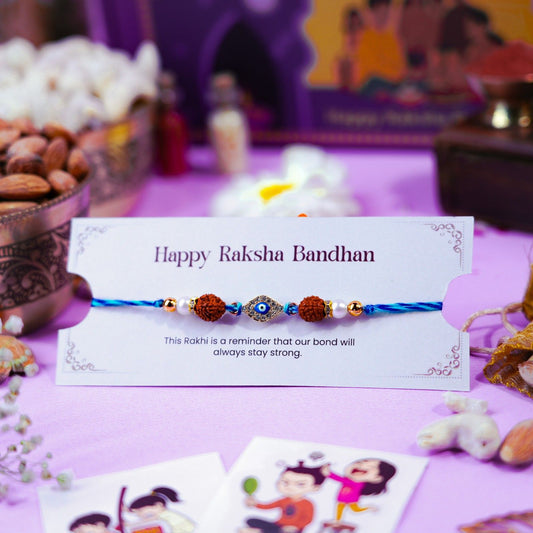Evil eye rakhi with Rudraksha beads displayed on Raksha Bandhan greeting card.