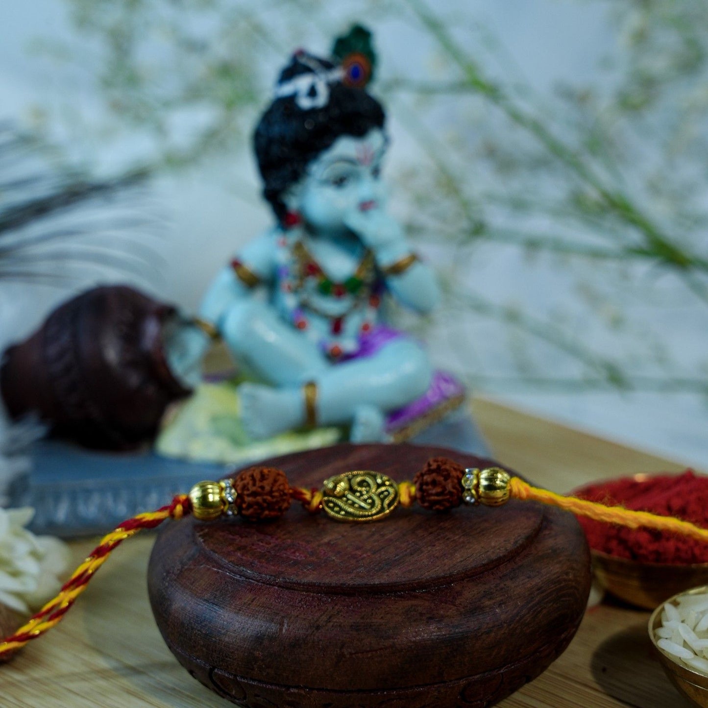 Spiritual Rudraksha Rakhi with Krishna idol for Raksha Bandhan gifting and festive rituals.