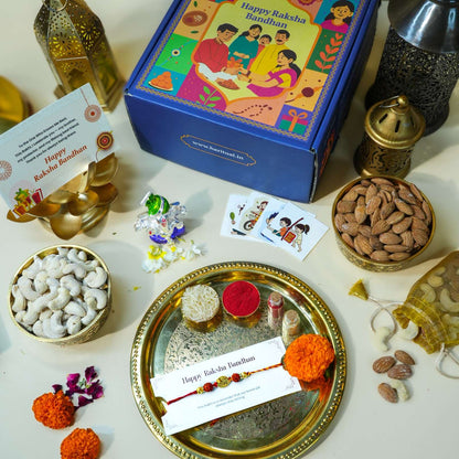 Raksha Bandhan gift set with Pagdi Ganesha idol, Rudraksha Rakhi, dry fruits, and pooja thali.