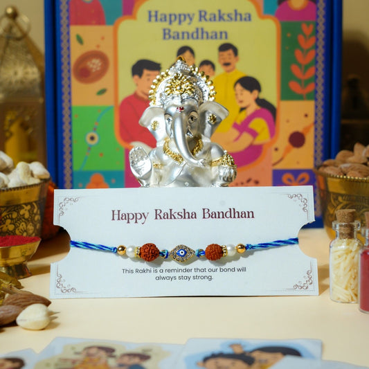 Evil Eye and Rudraksha Rakhi with silver gold Ganesha idol for Raksha Bandhan gift.