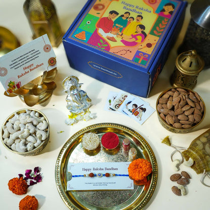 Raksha Bandhan gift set with Ganesha idol, Evil Eye Rakhi, dry fruits, and ritual thali.